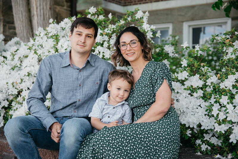 Alexis smiles with her son and husband.