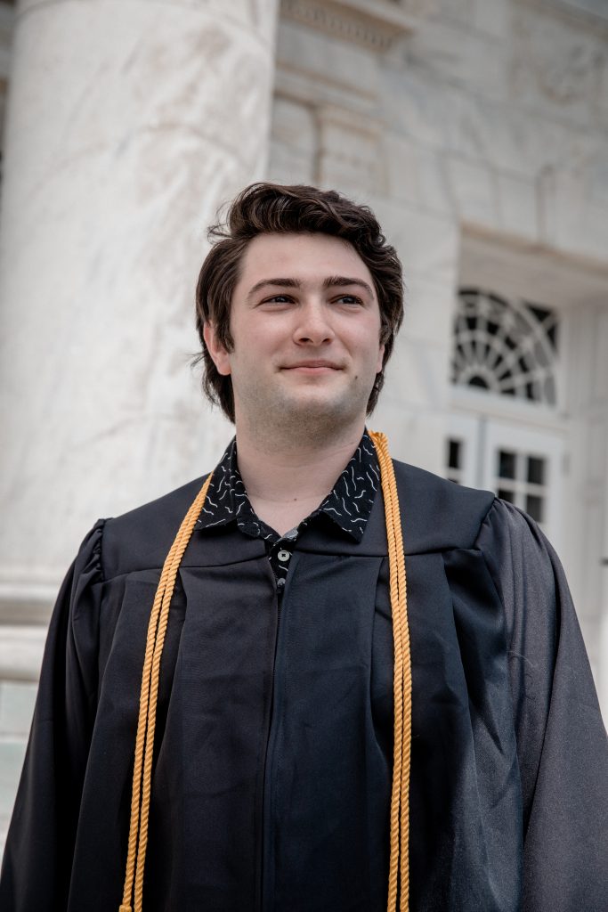 Josh standing at Bunce in his grad gear.