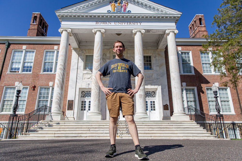 Kevin stands confidently in front of Bunce Hall.