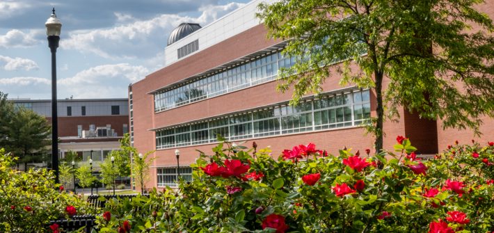 Photo of Science Hall and flowers in the foreground.