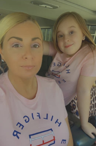 Sarah James poses with her daughter in matching shirts.