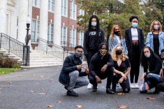 PROFFAMILY poses next to Bunce Hall.