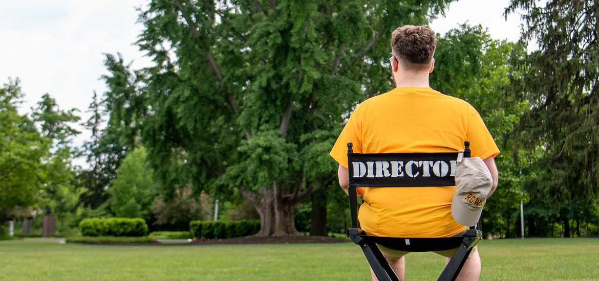 Nick sits in a director's chair on Bunce Green.