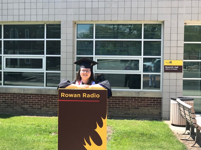 Mandi outside Bozorth Hall with Rowan Radio sign.