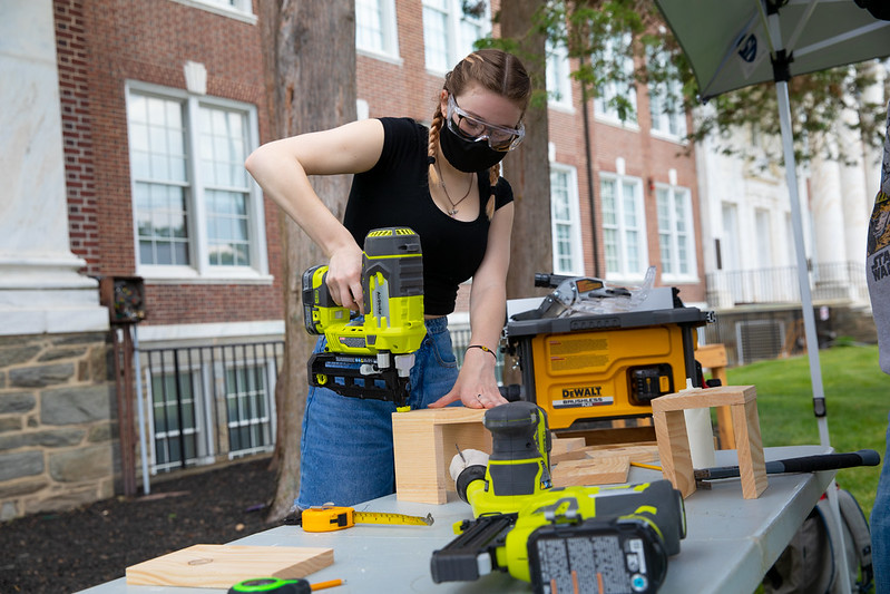 Stagecraft Fundamentals student, Jenna Hope, using power tools in class.