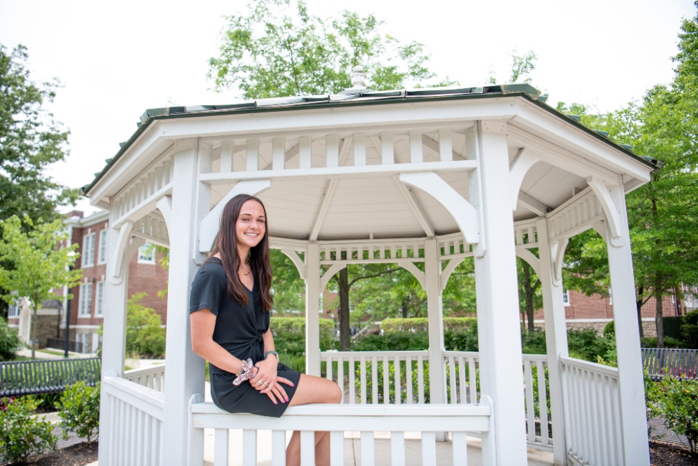 Natalie sits in a gazebo near Bunce Hall.