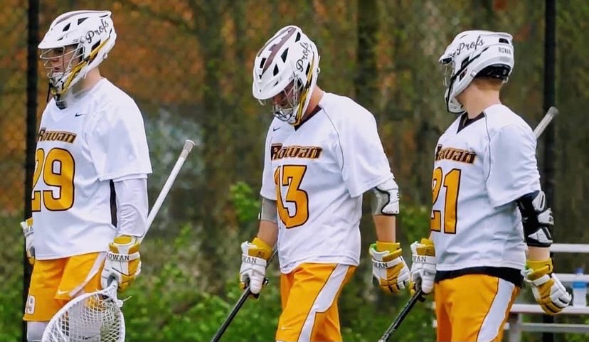Rowan Men's Club Lacrosse goalie and defenders walking onto the field for a game.