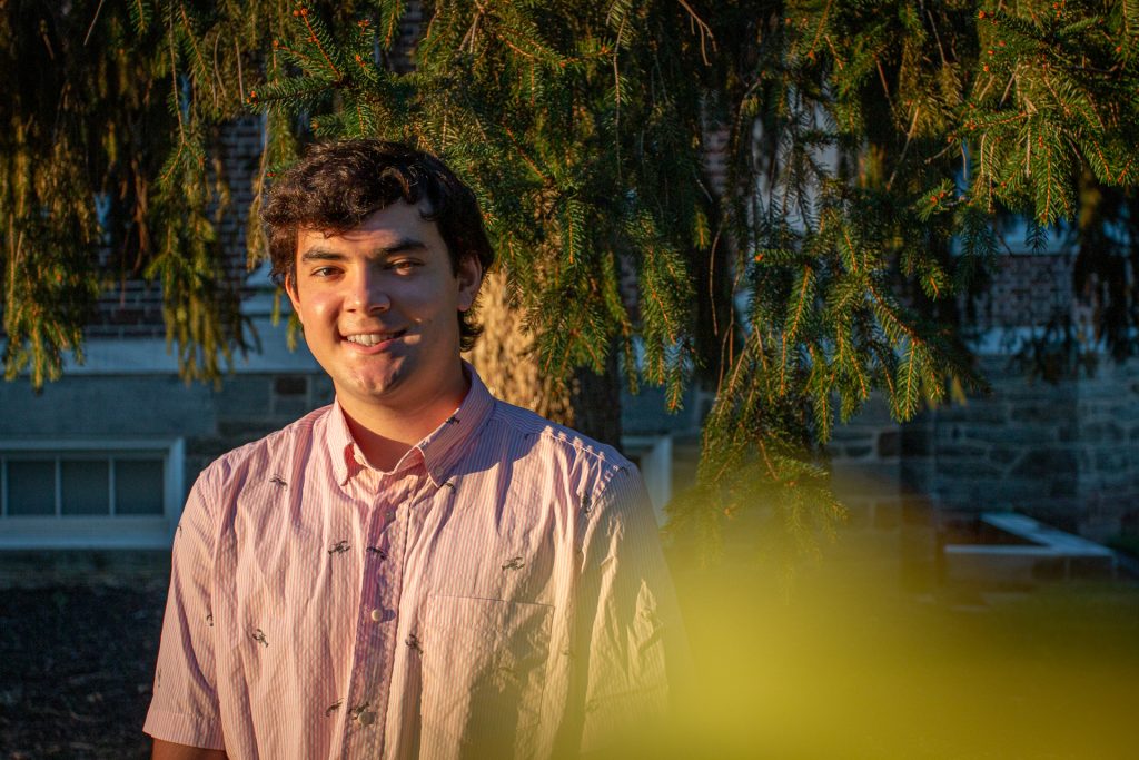 Nick poses in front of a tree.