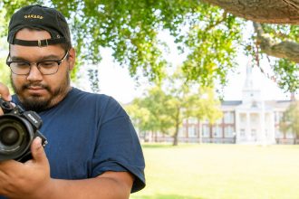 Alex adjusts his camera settings on Bunce Green.