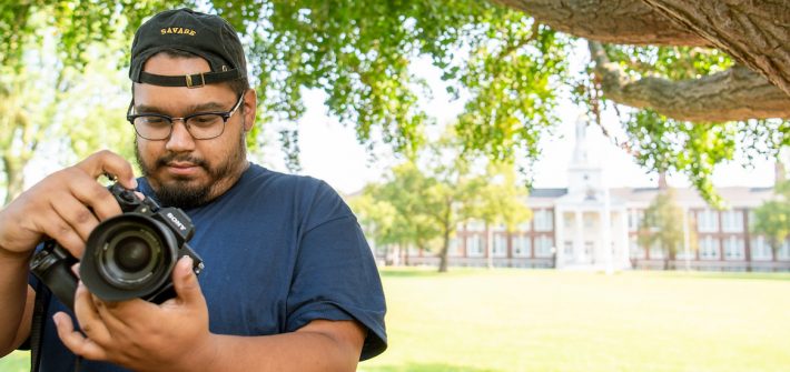 Alex adjusts his camera settings on Bunce Green.