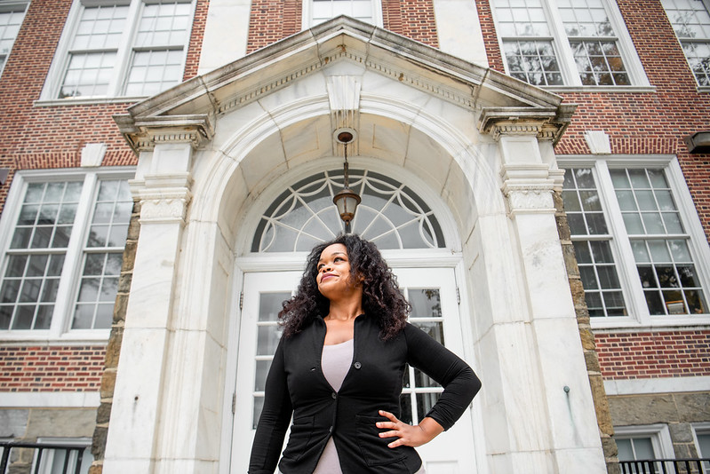 Psychology major Mel looks up in front of a side entrance at Bunce Hall.