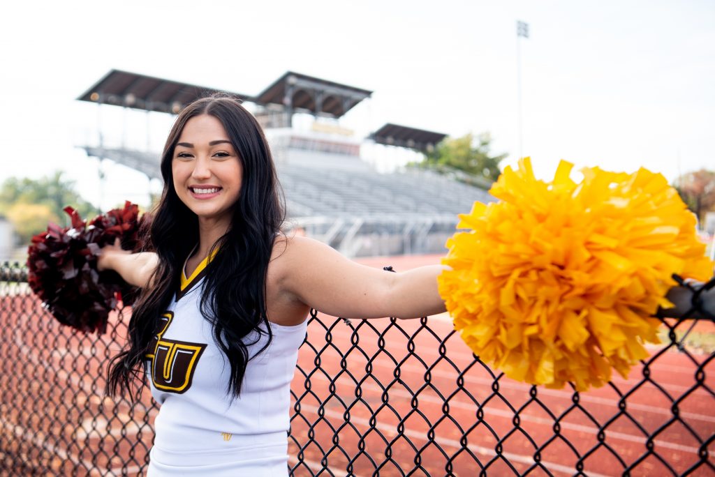 Gianna Moyer posing outside Richard Wackar Stadium.