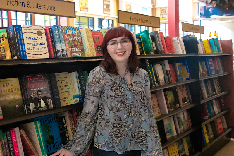 English graduate Nicole stands in the literature stacks in Rowan Barnes and Noble.