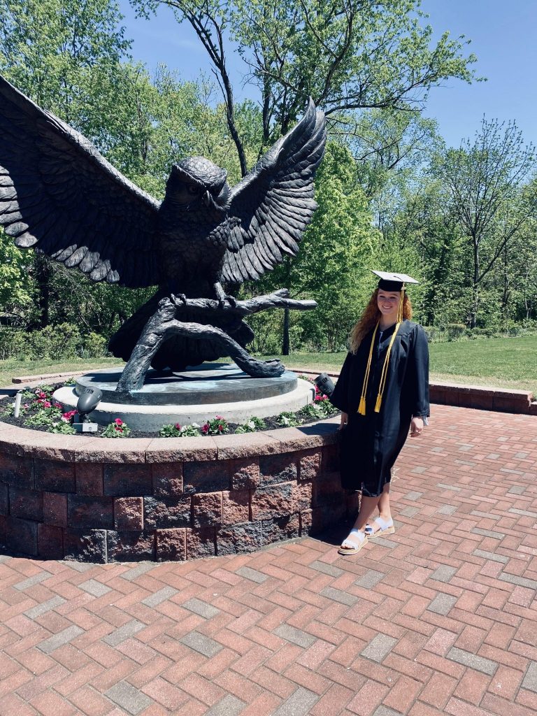 A photo of Chloe as she graduated from Rowan at the Prof statue.