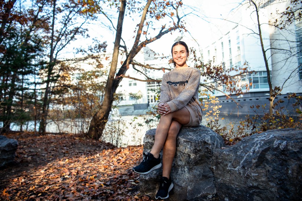 Trinity poses on a rock in front of the engineering pond.