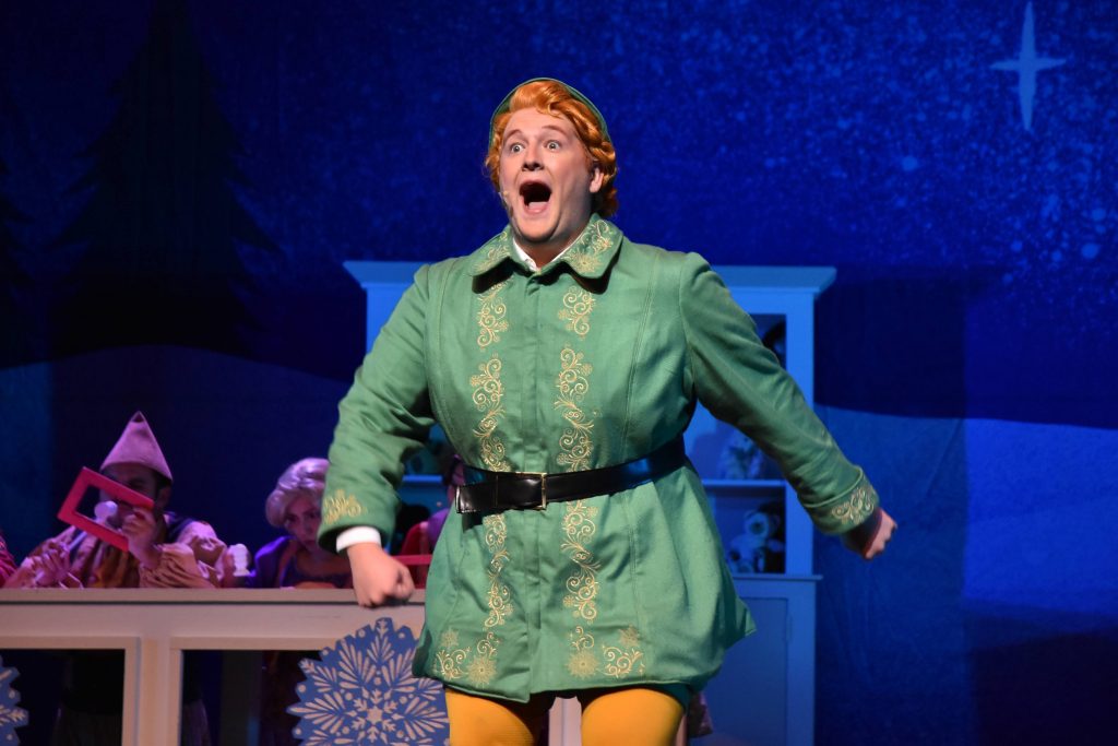 Nick makes a surprised expression as Buddy the Elf in a performance of Elf the Musical.