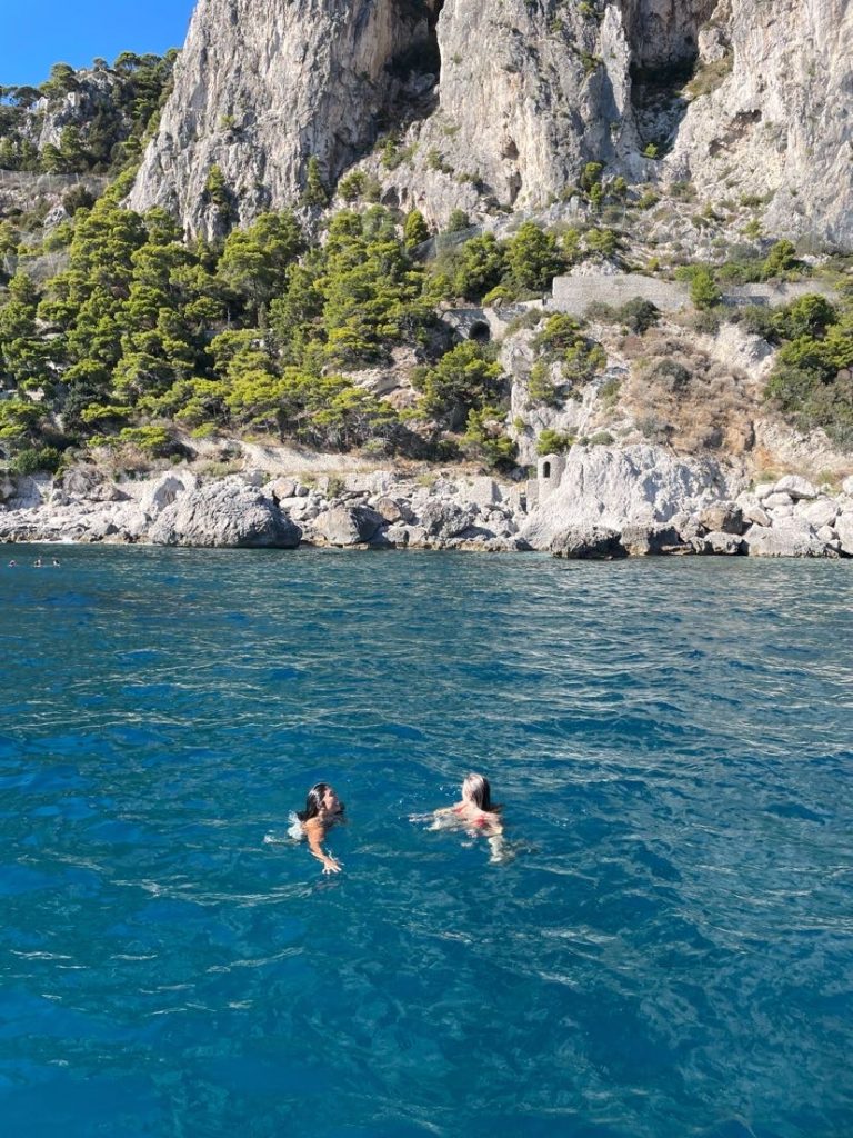 Calysta (left) with friend (Naomi) swimming during a boat tour from the Amalfi Coast to Capri in southern Italy. 