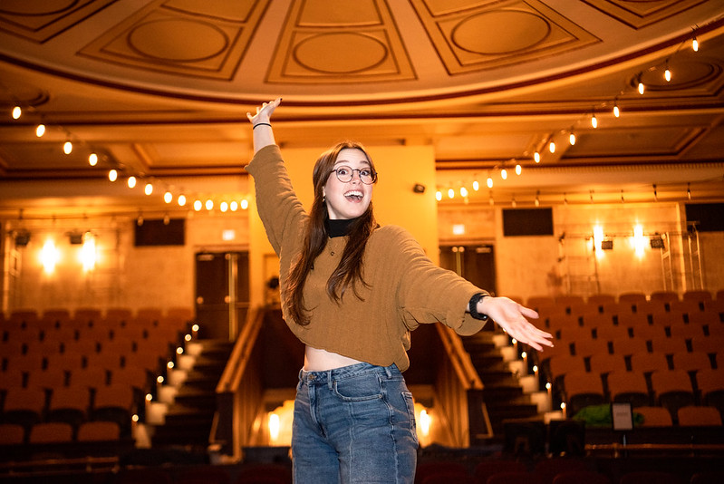 Kayla Bowe posing in Tohill Theatre in Bunce Hall.