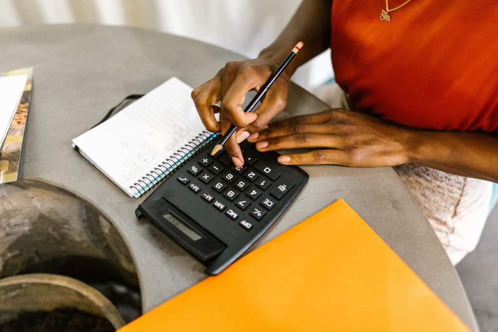A stock image of a person calculating and budgeting.