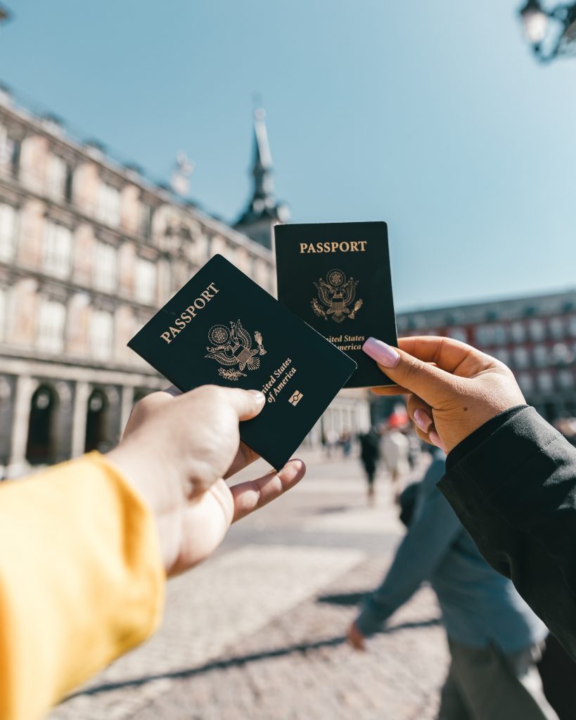 A stock image of two people holding passports.