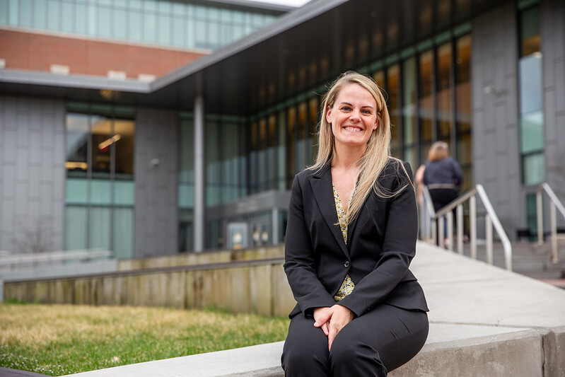 Amelia Gonzalez sitting outside of Rohrer College of Business.