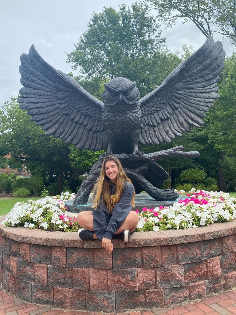 Valentina poses in front of the Prof statue.