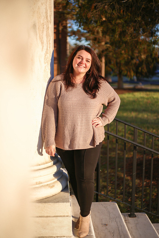 Catherine stands of the steps of Bunce Hall.