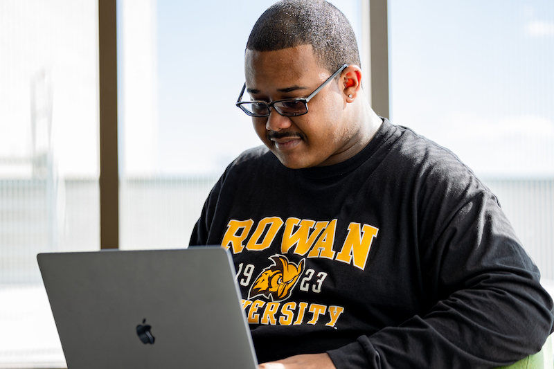 Jamar works on a laptop computer.