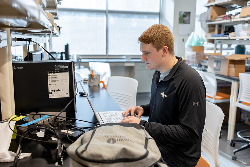 Matthew Beck sitting in a lab room.