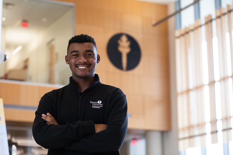 Bryan poses in front of the torch at Business Hall.