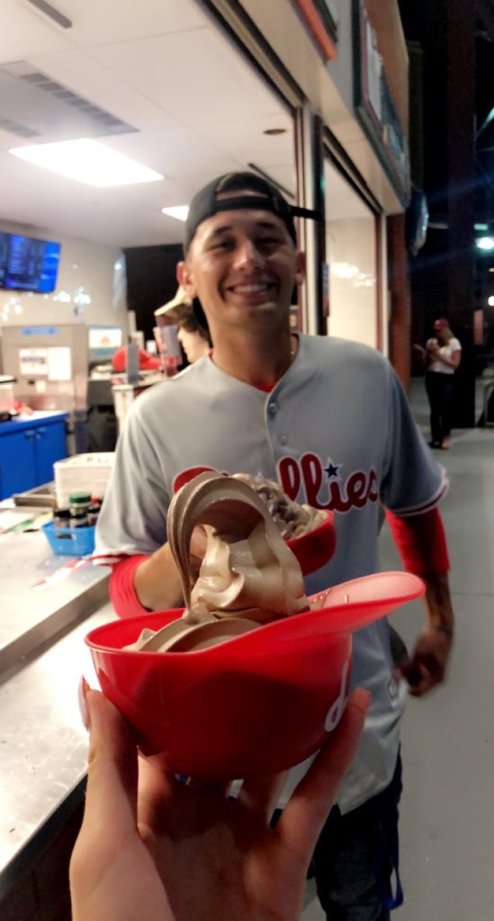 Thomas Cardona at a Phillies game with an ice cream cup in the foreground.