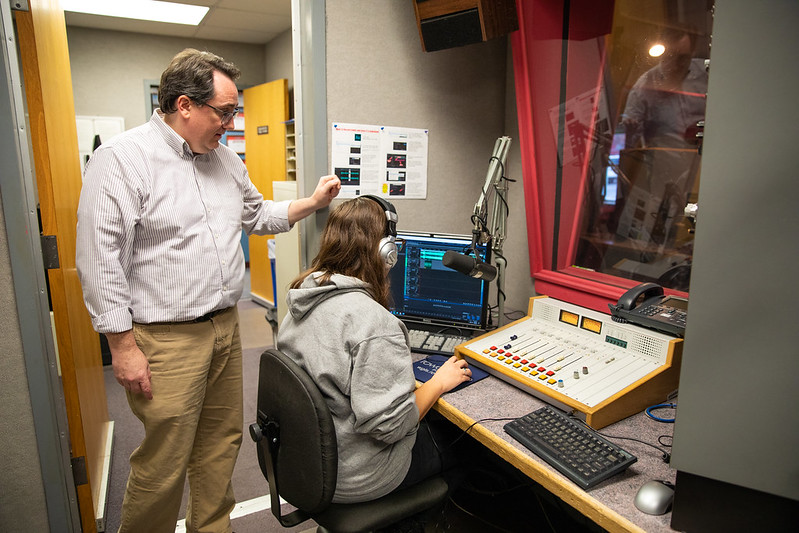 Leo helps guides a student at Rowan Radio