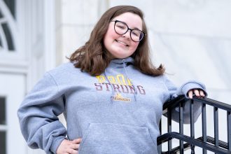 Lauren stands on the steps of Bunce Hall.