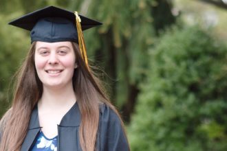 Liliana wears her graduation cap and gown.