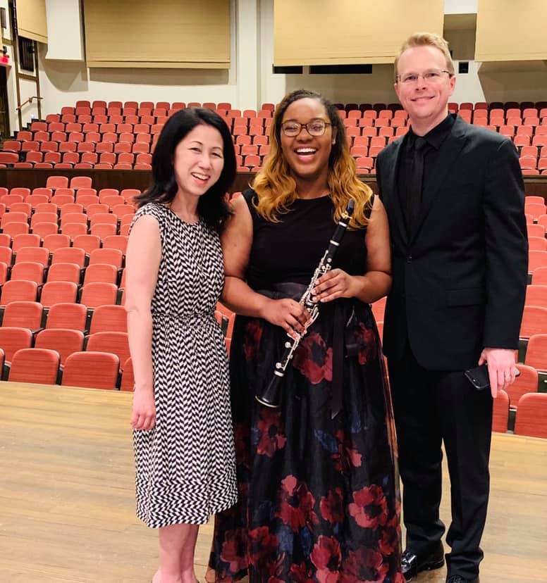 Lia Boncoeur (center) on the stage of Pfleeger Concert Hall after a Rowan University concert performance with clarinet professor Dr. Rie Suzuki (left) and Director of Bands Dr. Joseph Higgins (right).