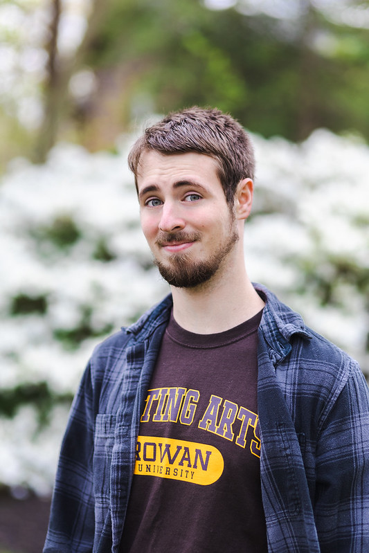 Headshot of Eric wearing a Writing Arts T-shirt.