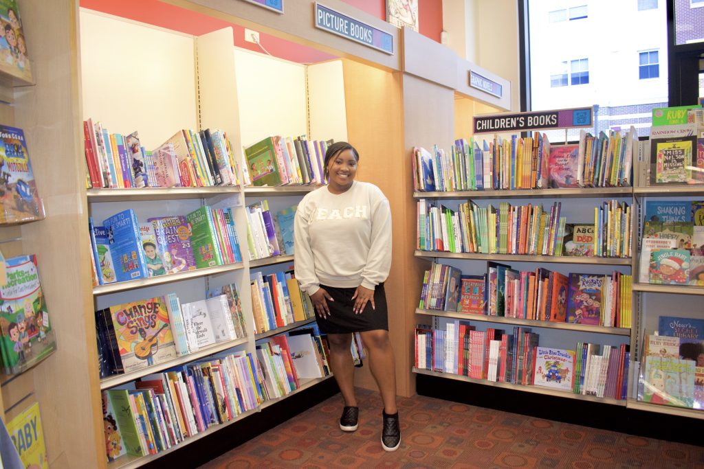 Mariah stands in front of a children's books section at Barnes & Noble.