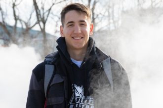 Outdoor shot of Marko wearing a coat and backpack.