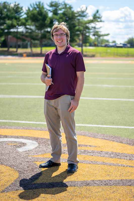 Larry stands at the 50 yard line inside Wackar Stadium.