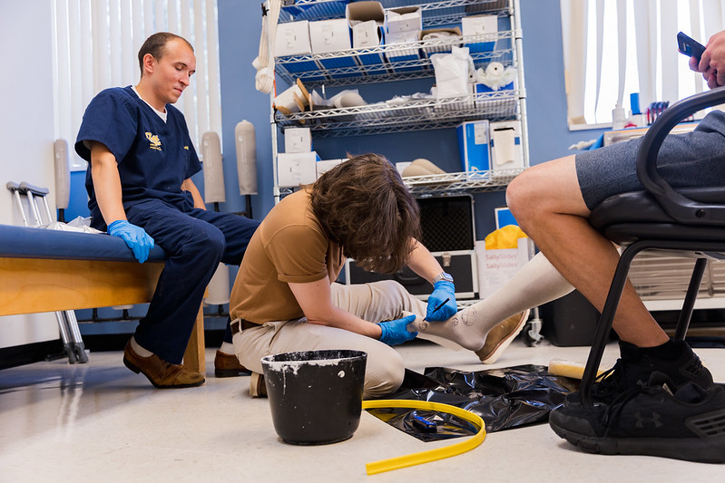 Dominic draws on a foot in preparation for fitting a prosthetic.