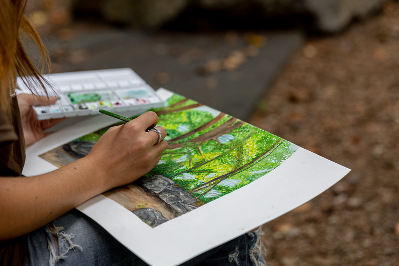 Brooke paints a wooded scene behind the engineering building.
