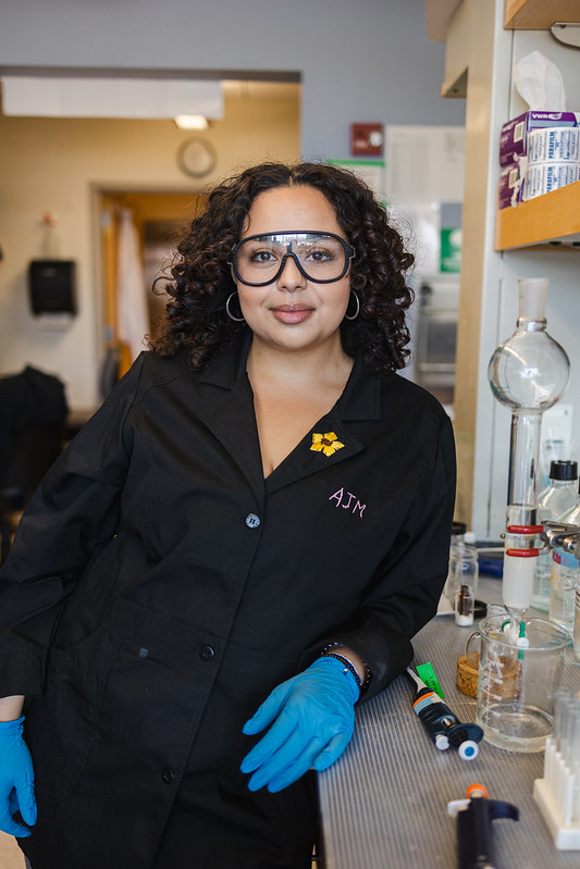 Biological Sciences major Aryana Marquez smiles and wears safety glasses in her research lab.