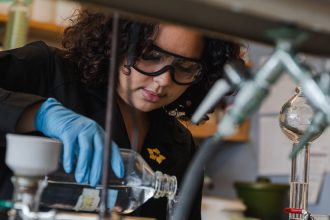 Rowan Biological Sciences major Aryana M. works in a lab.