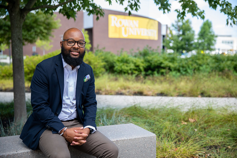 Dr. Adrian Barnes sits outside Wilson Hall.