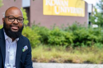 Music Education Assistant Professor Dr. Adrian Barnes sits outside Wilson Hall.