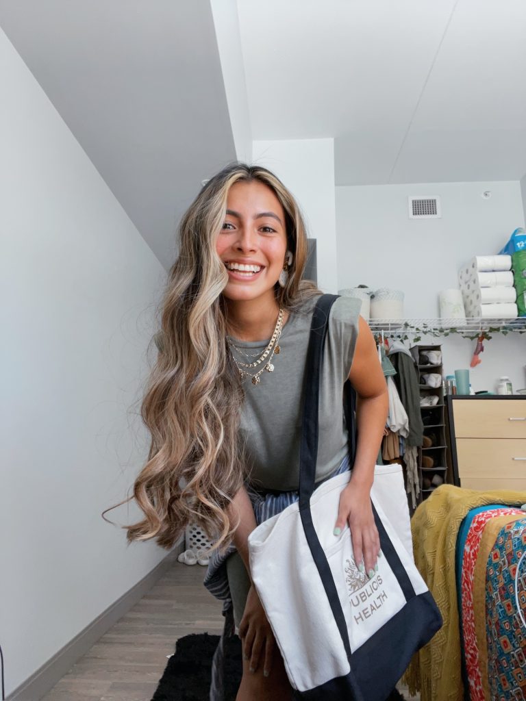 Angie smiles in a dorm.