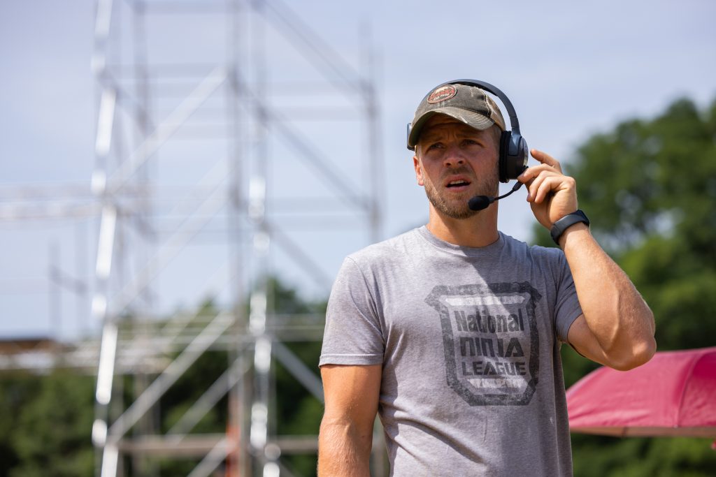 Chris wears a headset and works during a competition.