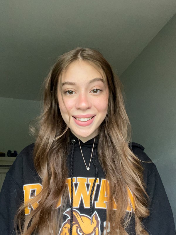 Grace poses for a photo wearing Rowan apparel.