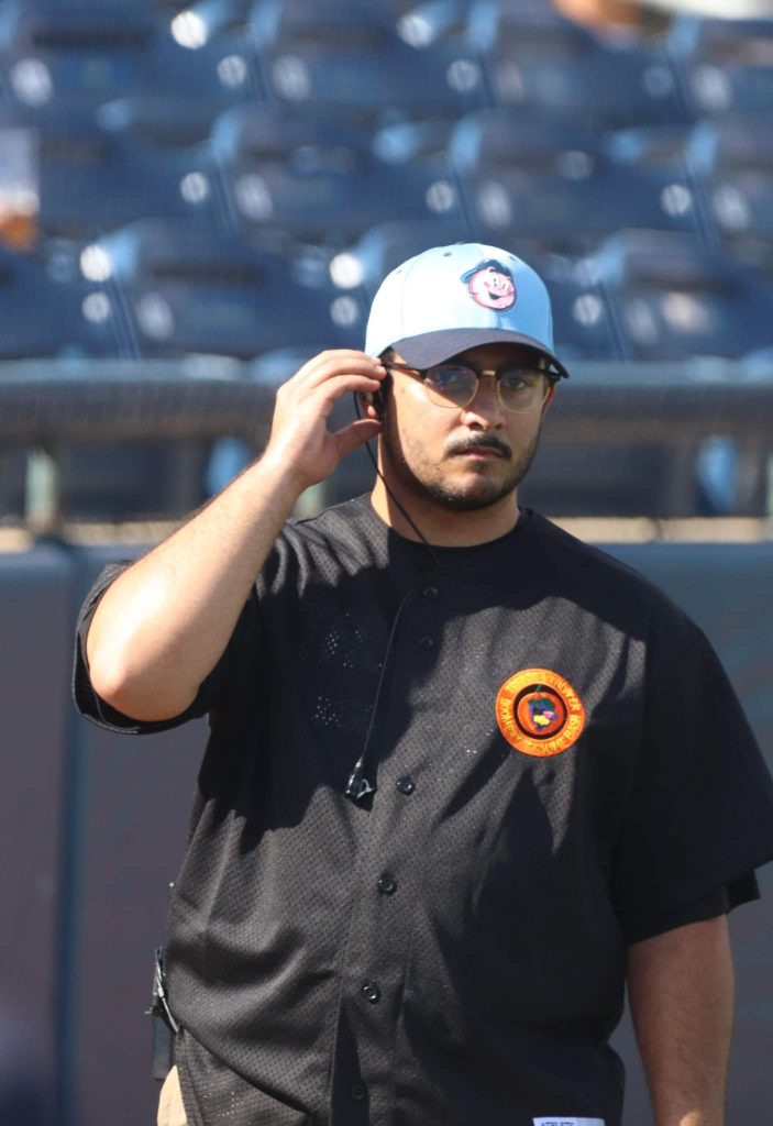 Spencer Reyes listening to earpiece as the on field host for the Trenton Thunder, a member of the MLB Draft League on Halloween Night. 