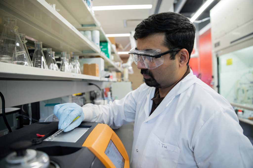 Amit working in an lab on campus.
